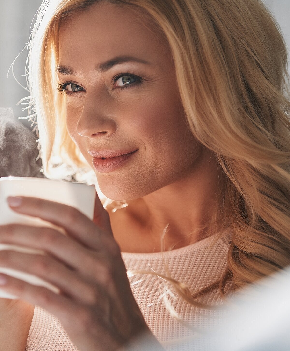 Smiling woman with long, light brown hair.