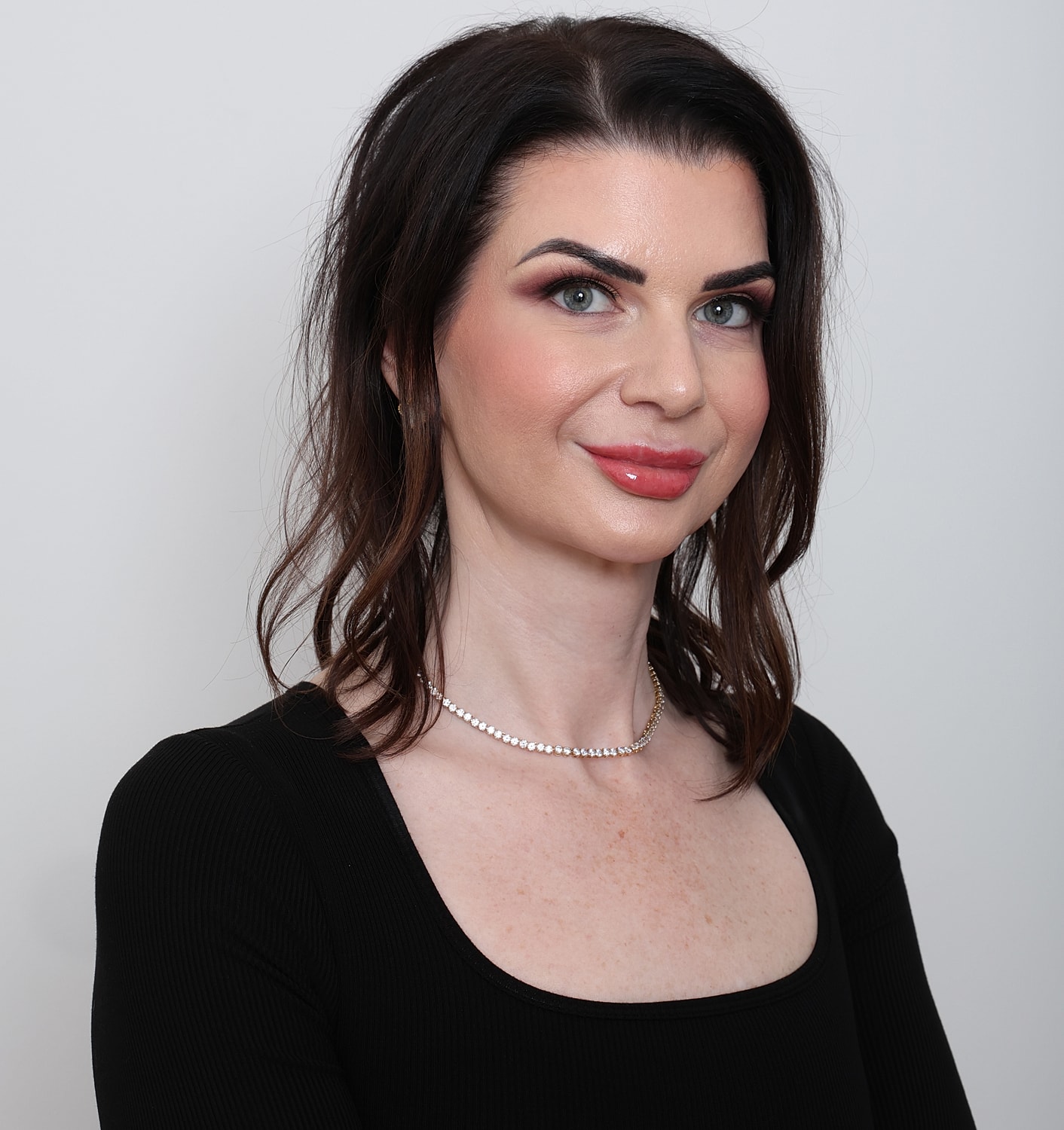 Woman with long hair in black top.