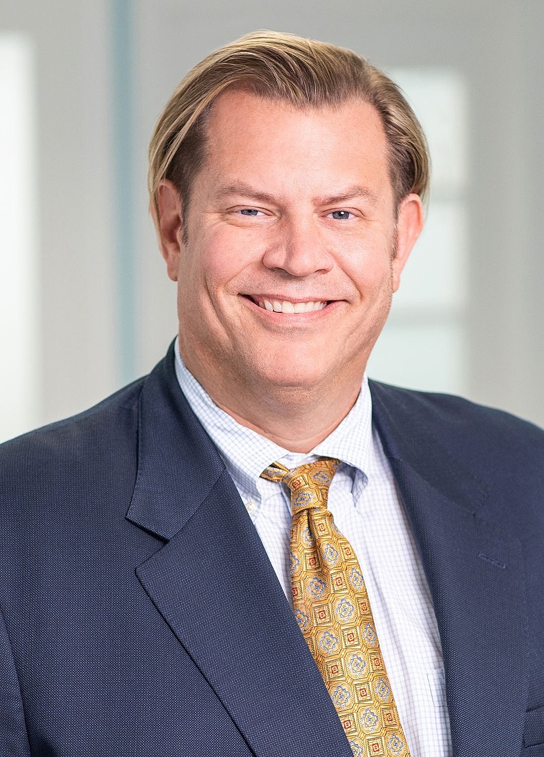 Smiling man in a suit and tie.