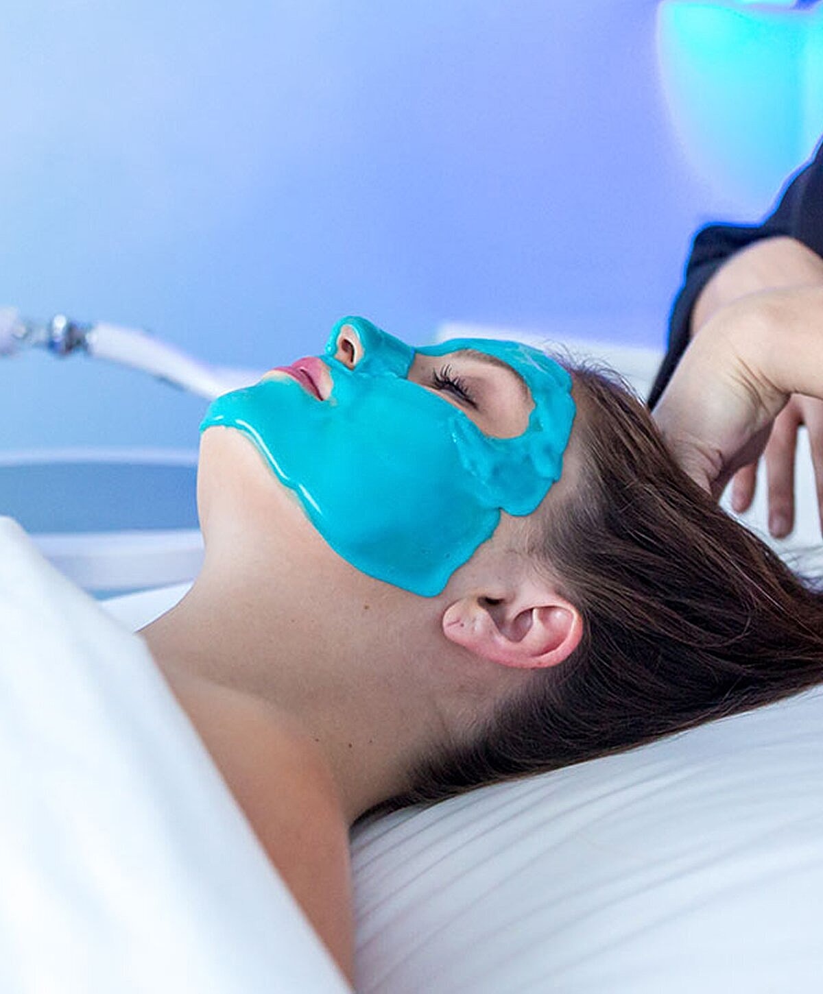 Woman relaxing by a pool, serene expression.