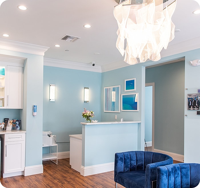 Woman receiving laser treatment near eye.