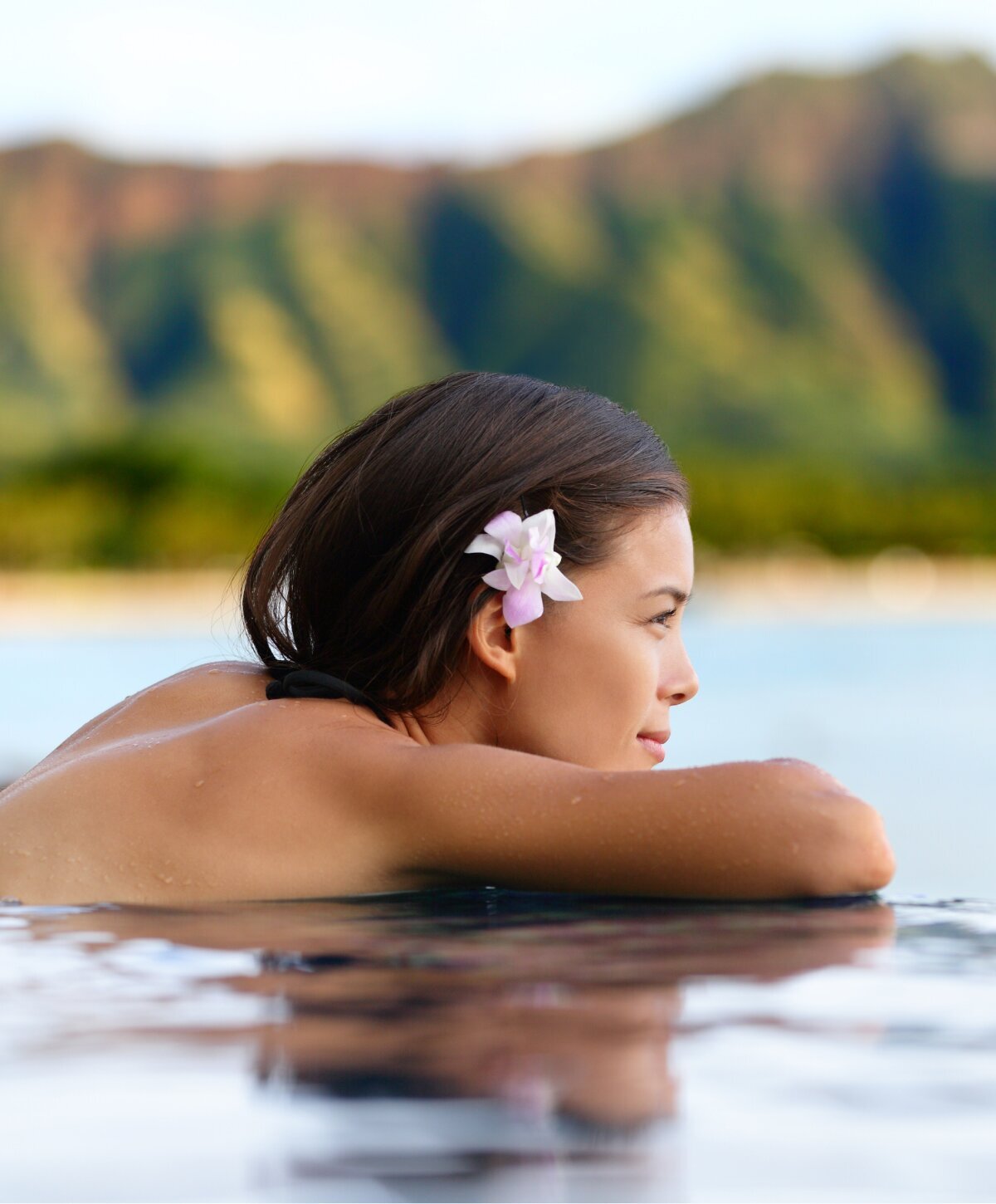 Woman in Infinity Pool with flower in hair